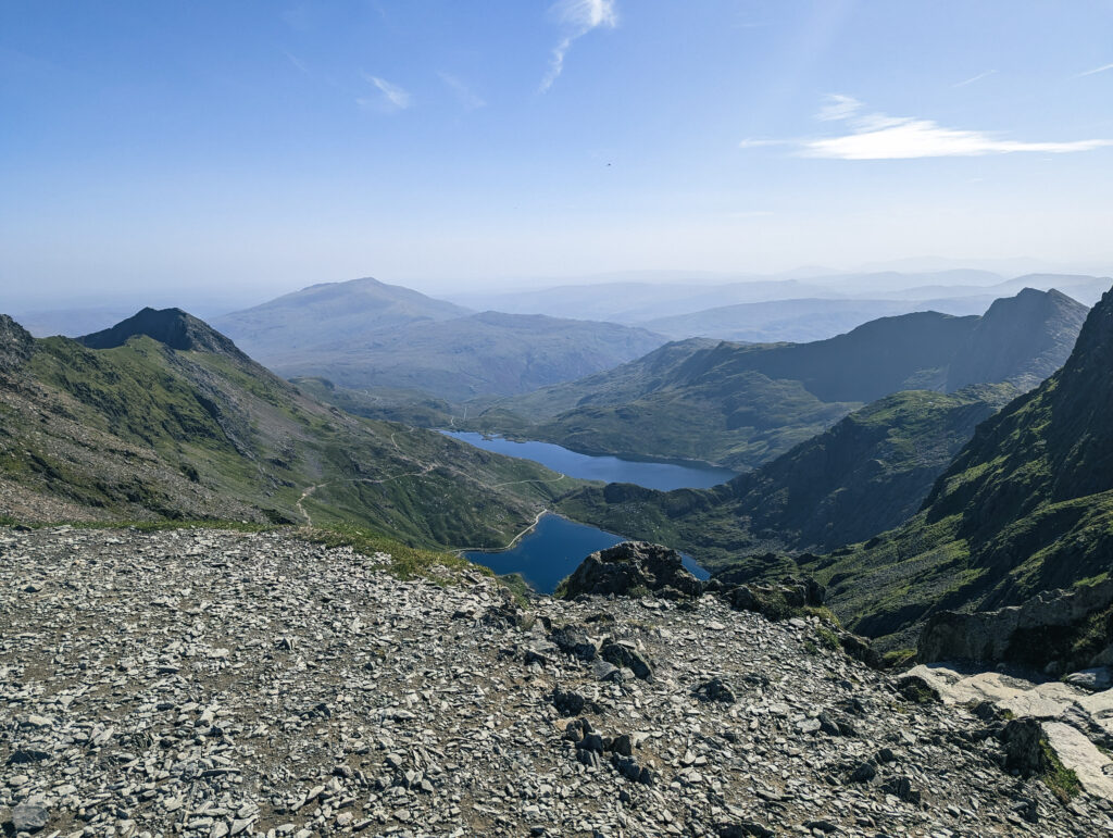 a view from near the summit of Mount Snowdon, including peaks and a lake