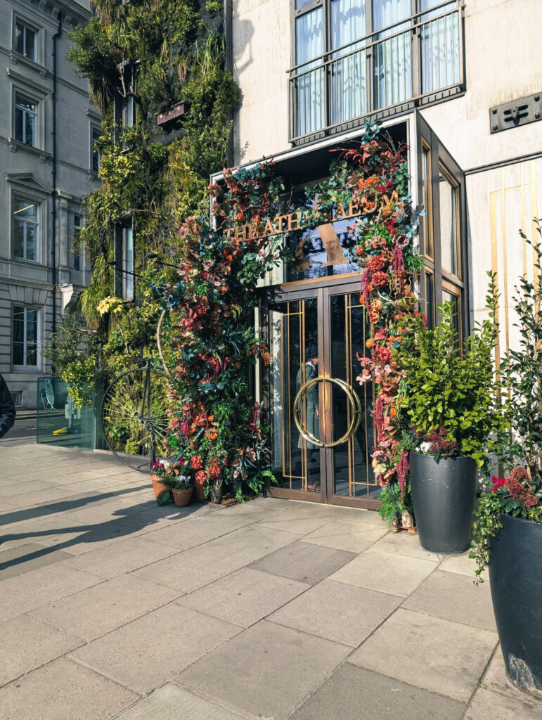 entrance to the luxury athenaeum hotel. the door is surrounded by flowers