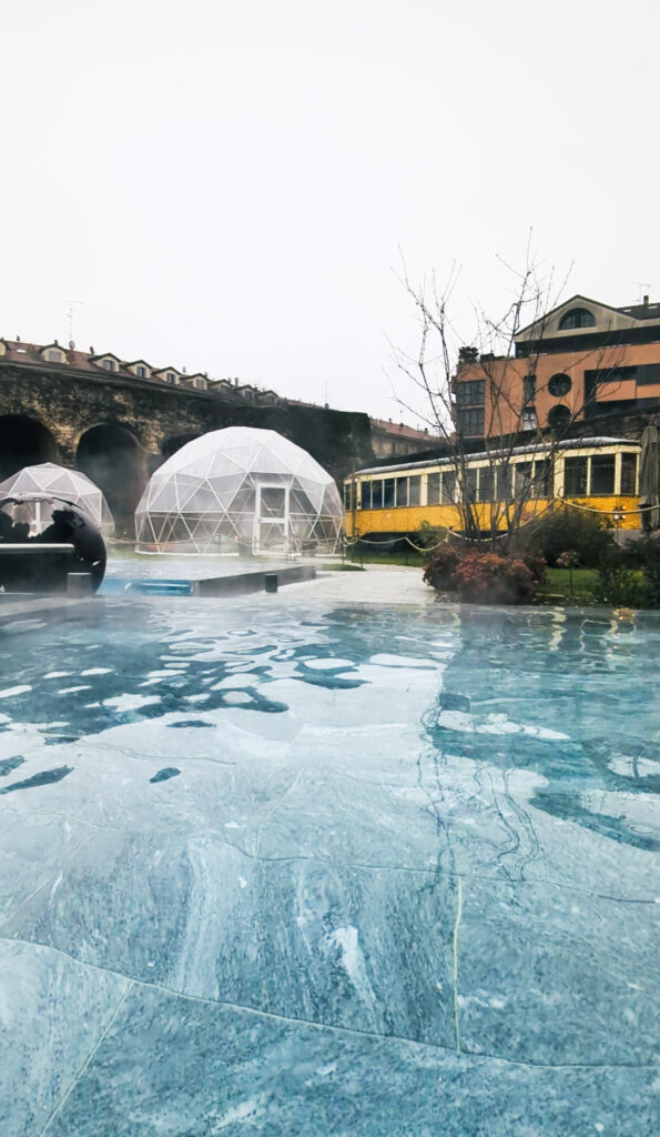 View of QC Termemilano's outdoor garden area taken from inside the thermal pool